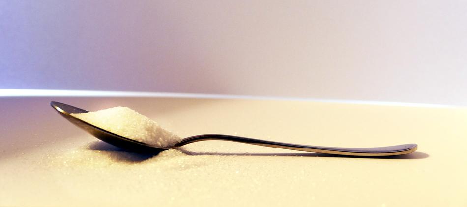white sugar in an iron spoon