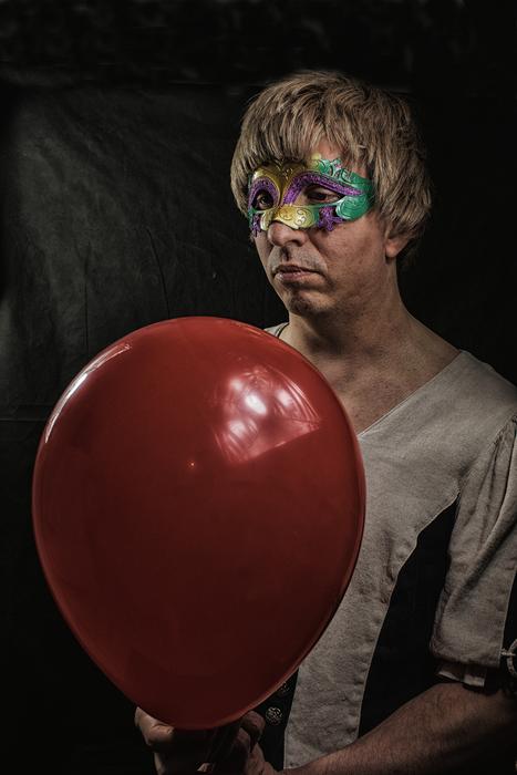sad man with a red balloon