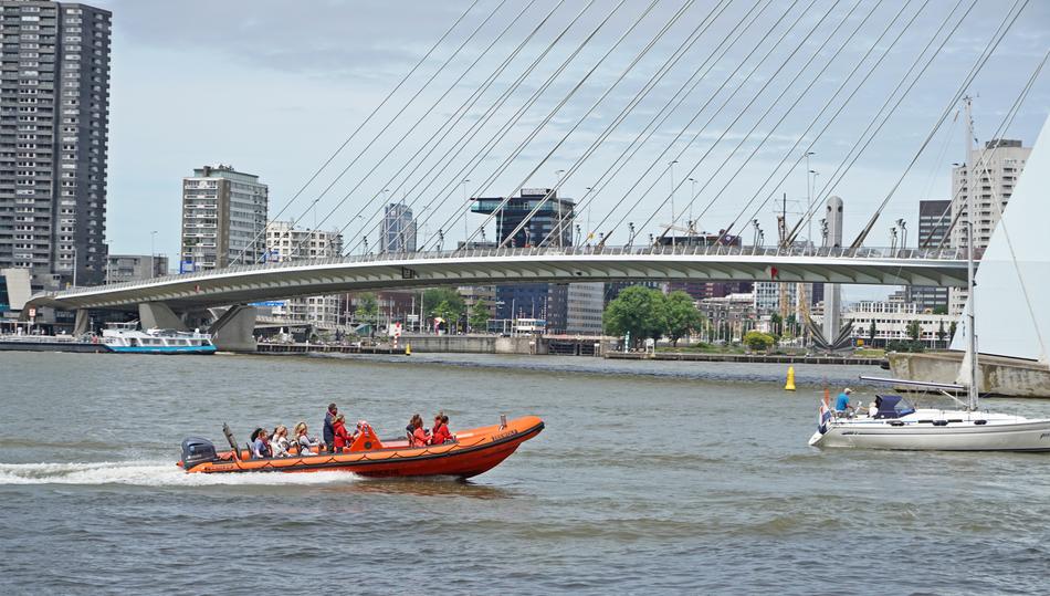 red boat in the water on the bridge