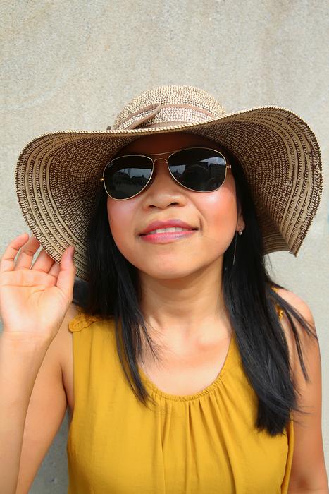 the girl in the hat with the black glasses is beautiful.