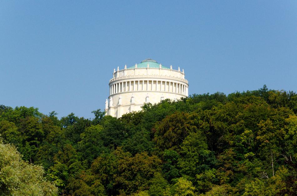 green trees with a white building
