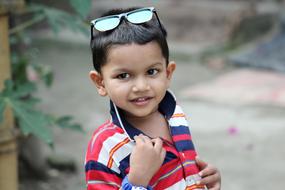 cute boy with sunglasses on his head