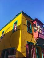 yellow house with colored balconies