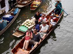 people in a boat on city canals