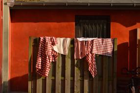 colored kitchen towels on the fence