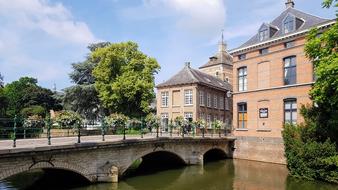 stone bridge with a house and trees