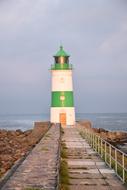 white lighthouse with green stripes