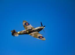 an old airplane in the blue sky