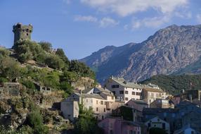 green trees with buildings on the cliff