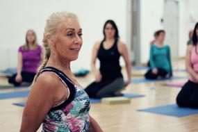 twisting yoga pose in blurred background