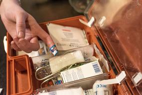 photo of a plaster on a finger and a first aid kit