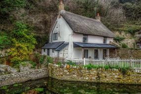 a beautiful house with a fence by the lake