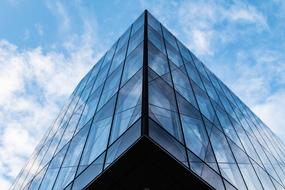 glass triangular building in the city