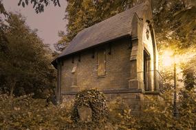 a stone barn with a lantern light.