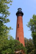 a red lighthouse against a blue sky