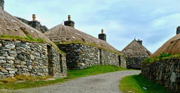 old stone houses in the grass