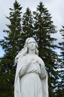 stone sculpture of a girl in the park