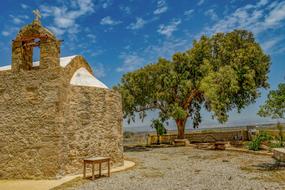 an old architectural building with a tree