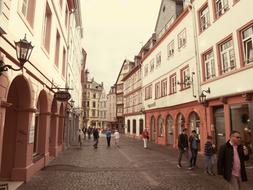 a cozy european street with people