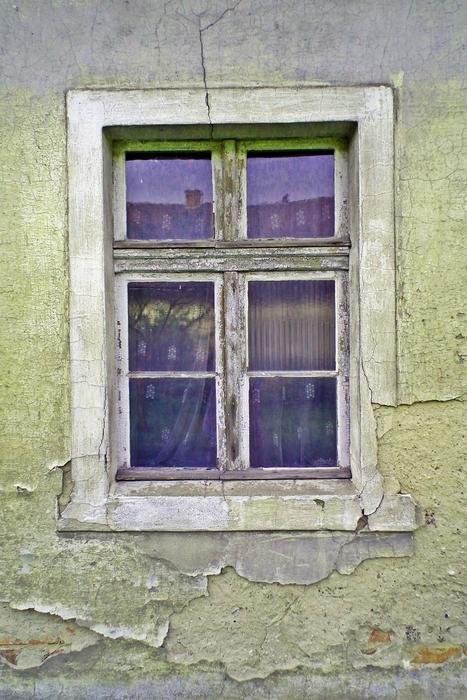 the window with the curtains is old