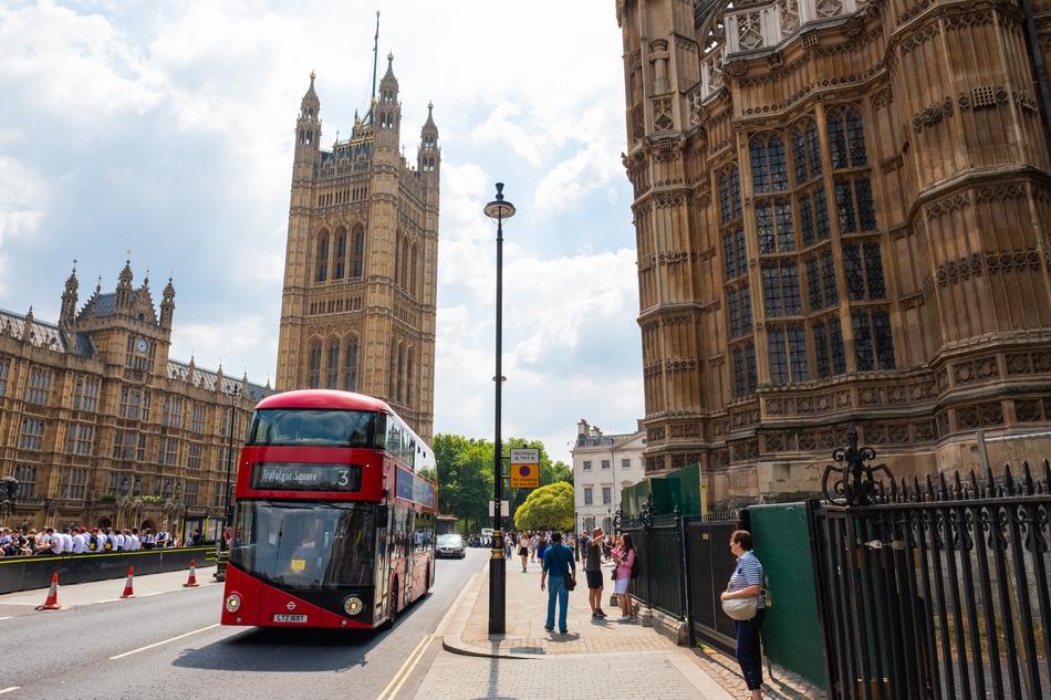 a red bus with people on the street
