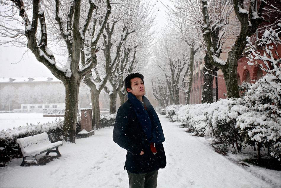 a man in a suit on a snowy road