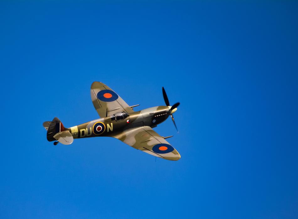 an old airplane in the blue sky