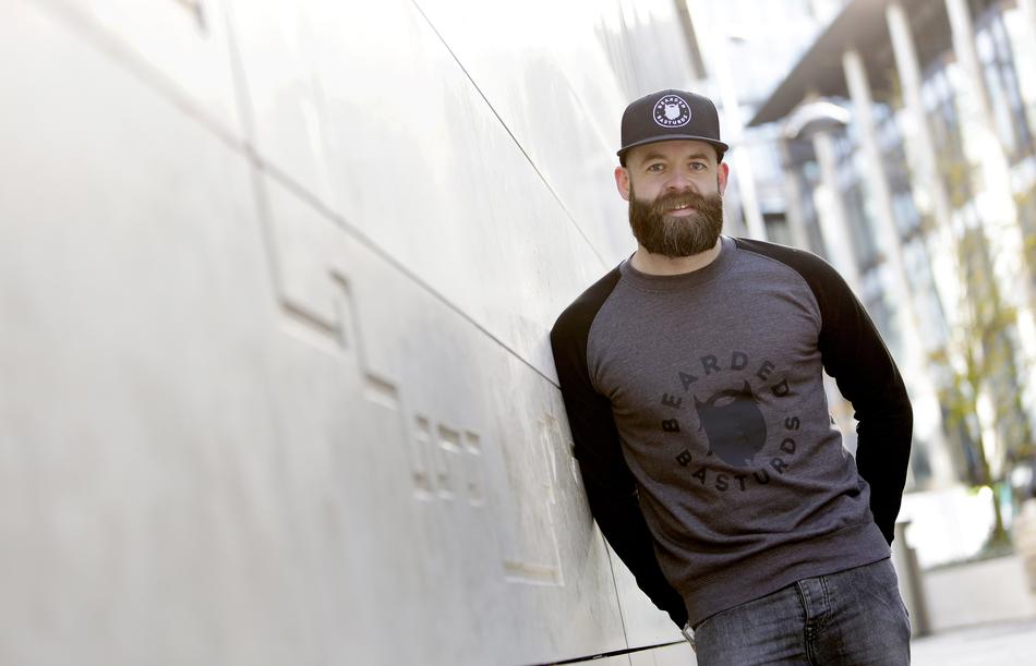 man with a beard against the wall