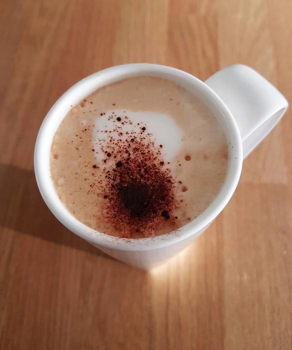hot mug of coffee on a wooden table