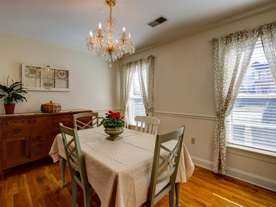 a cozy room with a chair and chairs