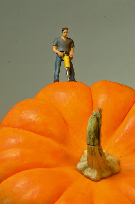 figure of a man on a large pumpkin