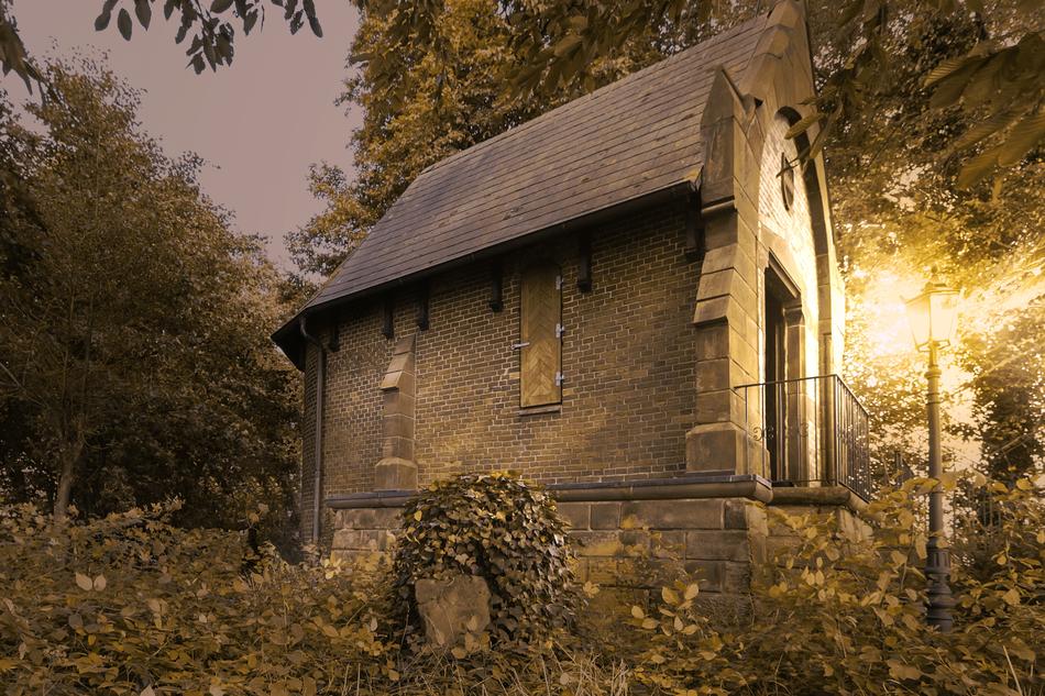 a stone barn with a lantern light.