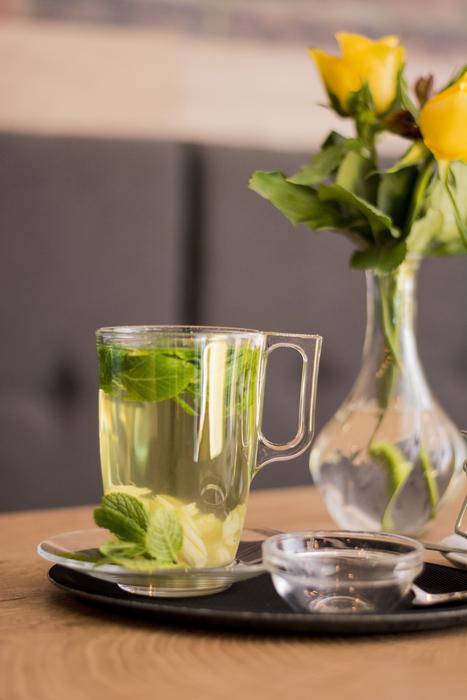 healthy tea with lime on a background of flowers