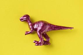 pink dinosaur on a yellow background