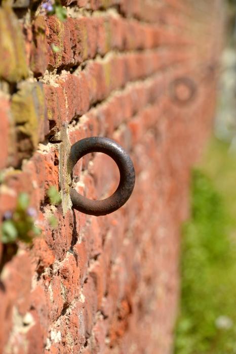iron hook on the red wall