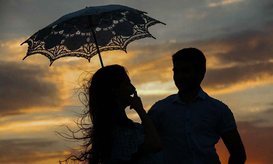 silhouettes of people with umbrella view