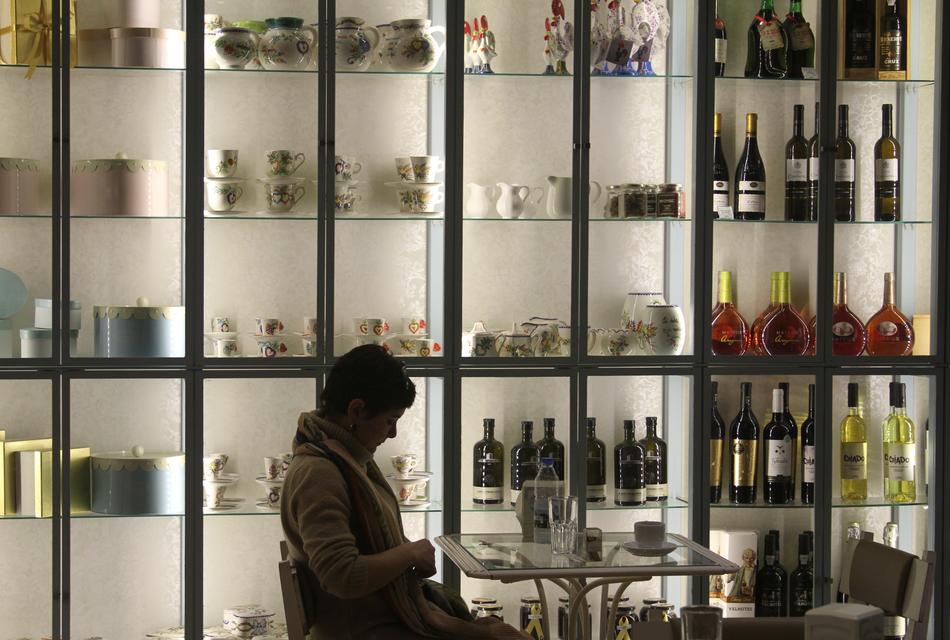 woman against a glowing wall of bottles