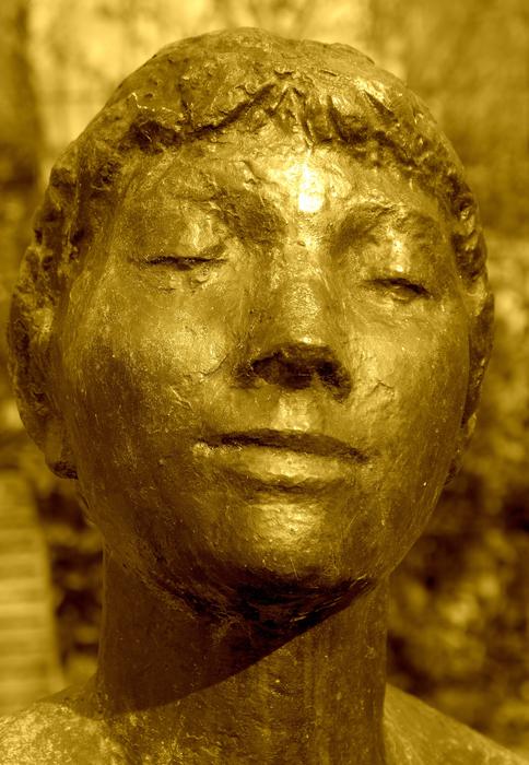 girl yellow stone sculpture