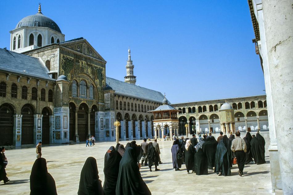 girls in black burqas at the temple