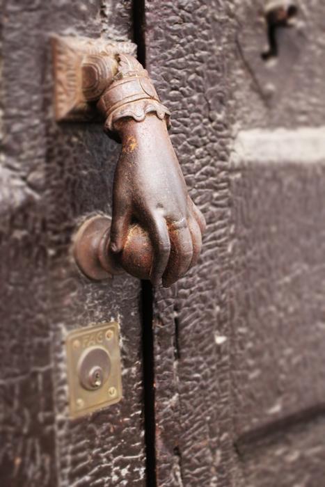 man's hand sculpture door