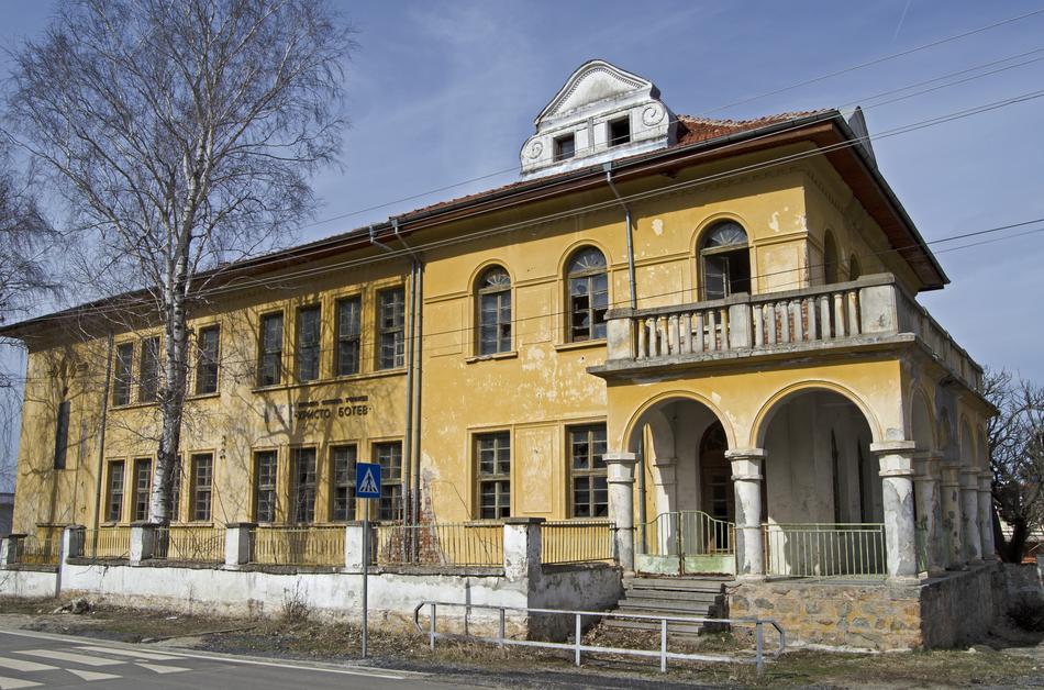 yellow house with white balconies