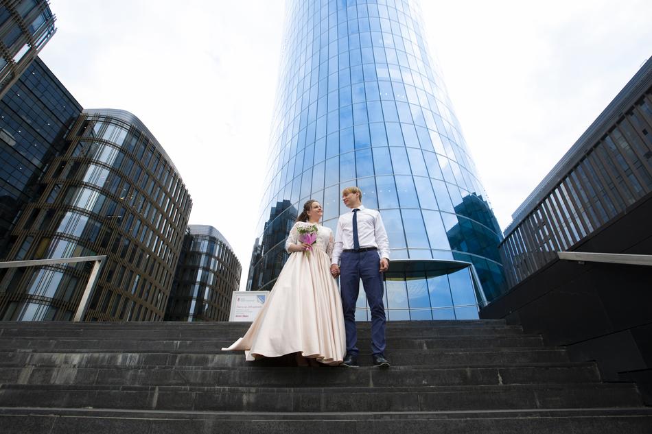 a cute couple in front of the buildings