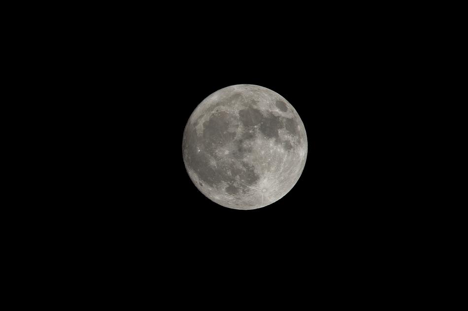 white moon in a black sky is a beautiful sight