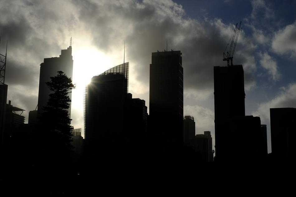 the black silhouette of tall buildings