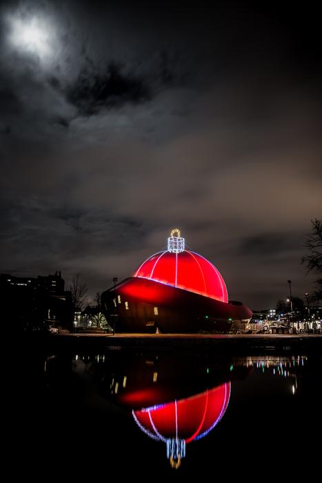 red glowing building by the water