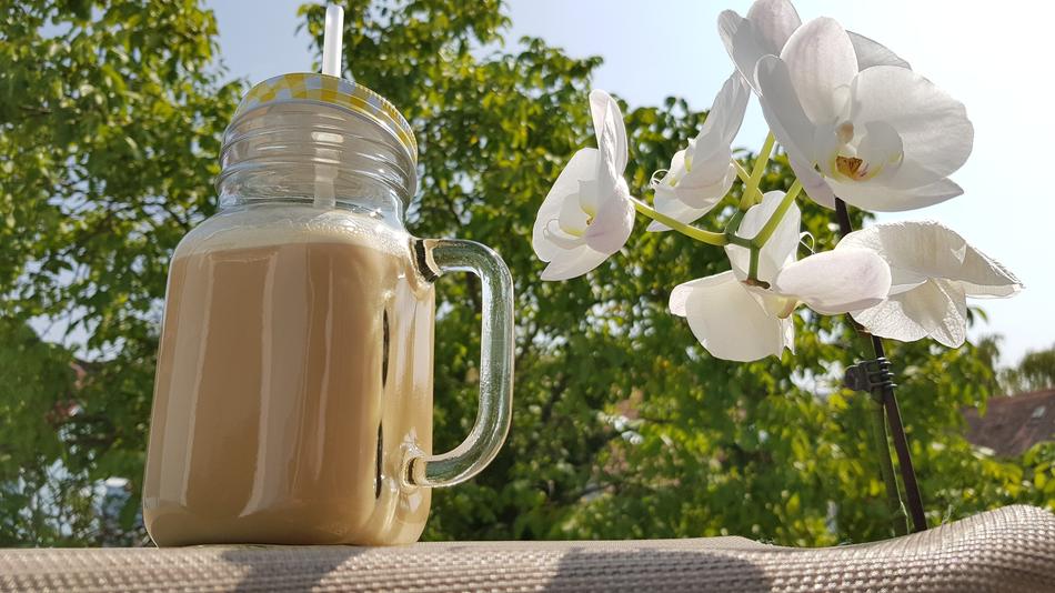 Coconut milk on a background of flowers