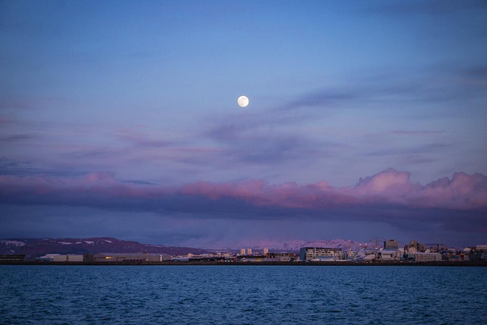 lake with clouds and moon in the background