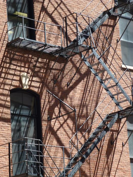 the staircase is black against the background of the building